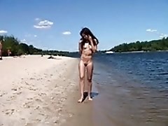 Naked teen nudist lets the water kiss her body